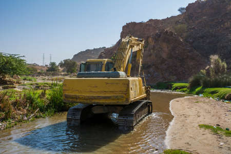 Excavator in riverの写真素材
