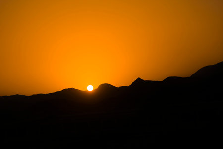 Sunrise scene with mountain silhouetteの写真素材