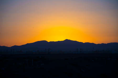 Sunrise scene with mountain silhouette