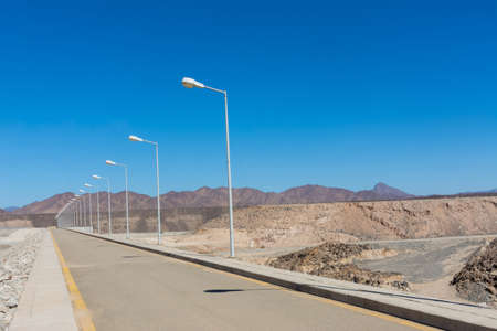 Beautiful road with street lights and mountain background, beautiful clear sky, Khulais, Saudi arabiaの写真素材