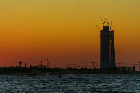 Jeddah tower under construction at red sea shore Jeddah, Saudi arabia, with sunset background