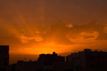 Sunrise with dramatic clouds and sun rays in countryside of Jeddah, Saudi arabiaの写真素材