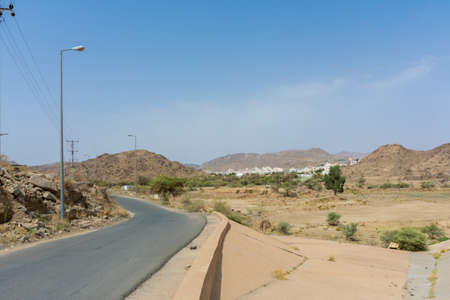 Beautiful road with mountain background, beautiful clear sky, Taif, Saudi arabiaの写真素材