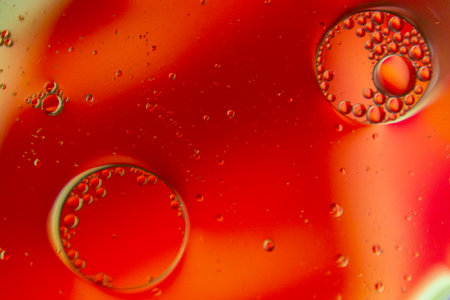 Bright and unique oil drops, circles on the water surface. Unusual background. Colorful background...