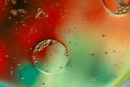 Bright and unique oil drops, circles on the water surface. Unusual background. Colorful background...