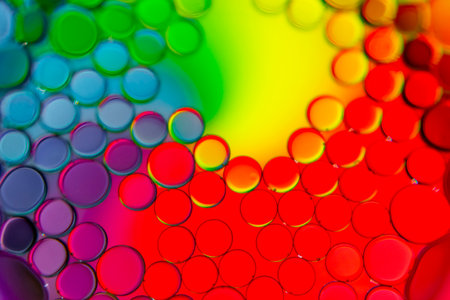 Bright and unique oil drops, circles on the water surface. Unusual background. Colorful background...