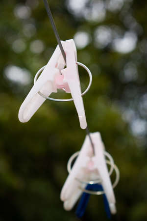 Closeup picture of light pink color cloth clip in a wire.の写真素材