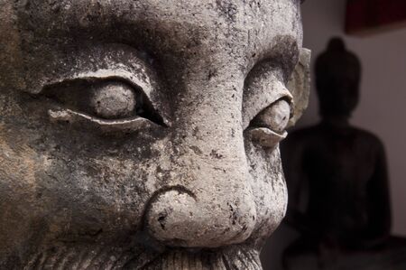 Statue face in The Temple of reclining Buddha  Wat Pho   Bangkokの写真素材