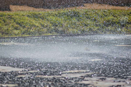 Rain water drop falling to the floorの写真素材
