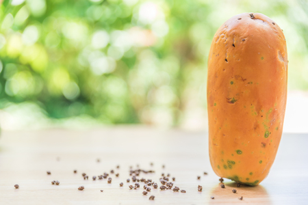Fresh papaya fruit on wooden table with blur backgroundの写真素材