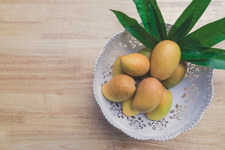 Mango on a wooden tableの写真素材