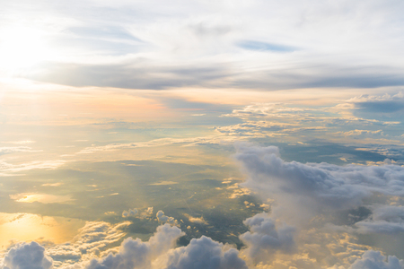White clouds and blue sky at sunrise, view from above air plane window.の写真素材