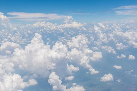 Blue sky and beautiful clouds. View from window of an airplane