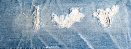 torn denim fashion jeans design texture. Blue denim jeans texture banner with copy space for text...