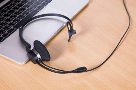Laptop computer with headset on keyboard