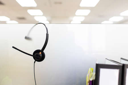 VOIP headset for callcenter on desk at customer service office. Communication support for sale support and telemaketing Helpdeskacの写真素材