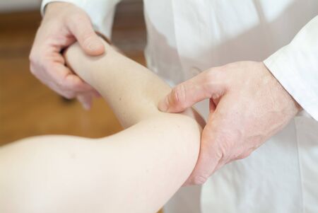 Physiotherapy for joint pain in the elbowの写真素材