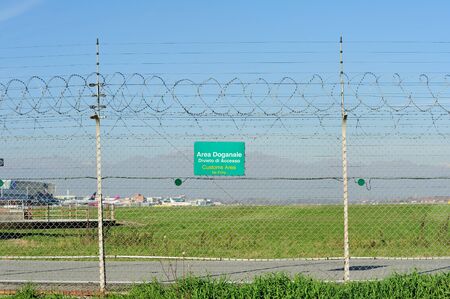 Customs Area signboard on a barbed wire at the airportの写真素材