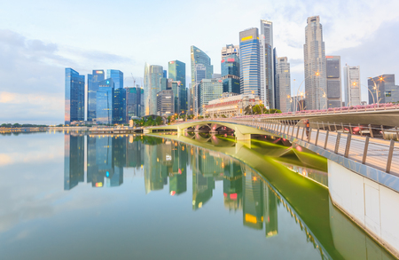 SINGAPORE - MAY 15,2016: Financial district skyscrapers and the Jubilee Bridge at Merlion Park. A newly created pedestrian bridge at Marina Bay links Merlion Park to the waterfront promenade.のeditorial素材