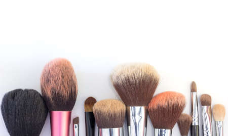 Set of essential professional make-up brushes are isolated with shadows on white background. Overhead viewの写真素材