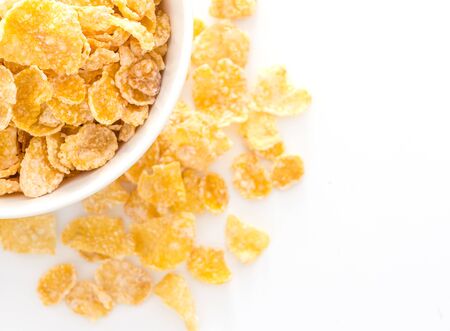 Cornflakes in a bowl, isolated on white background, Top view with copy space.