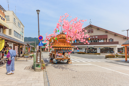 NIKKO, JAPAN - APRIL 16, 2014: A wooden hana-yadai is being walk around in downtown of Nikko to celebrate and welcome spring season with fancy Japanese costume, Nikko, Japanのeditorial素材