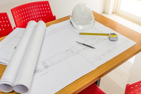 Workplace of architect - Architectural project, blueprints, blueprint rolls, pen and measuring tape...