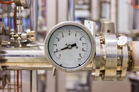Closeup of pressure gauge, pressure gauge for monitor condition. Pipes and valves at pharmacy industry manufacture factory.の写真素材