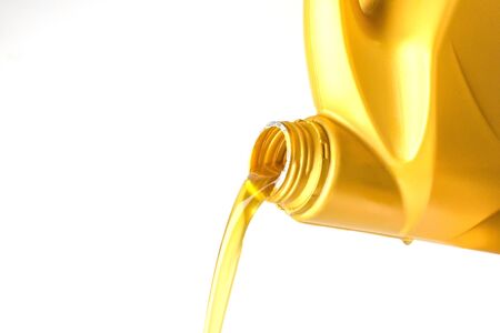 Pouring oil lubricant motor car from bottle isolated on white background, Closed upの写真素材