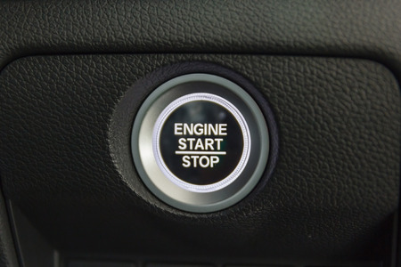Close up of Start/stop engine button in modern vehicle, Car interior.