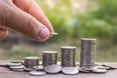 Saving money concept: Man's hand putting money coin stack, Money, Financial, Business Growth conceptの写真素材