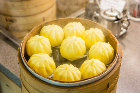Chinese dumplings(steamed stuff bun) being steamed on the traditional bamboo panの写真素材
