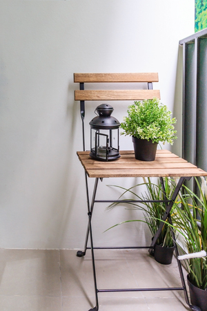 Living room Interior with flower pots and light lamp on the wooden chairの写真素材