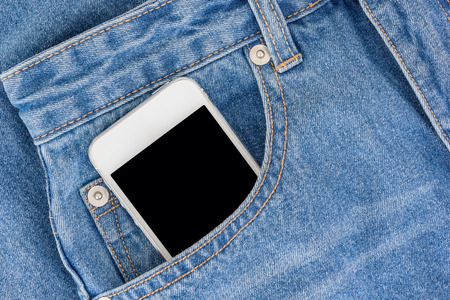 Smartphone with black screen with empty space for text in a jeans pocketの写真素材