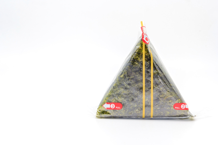 Portable Onigiri a Japanese rice ball wrapped with seaweed in sealed plastic on white background, with Copy space and text.の写真素材