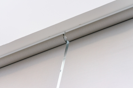Roll Blinds on the windows, the sun does not penetrate the house. Window in the Interior Roller Blinds. Beautiful Blinds on the Window, the Sun and Heat Protection, the Perfect Windows Interior Decorの写真素材