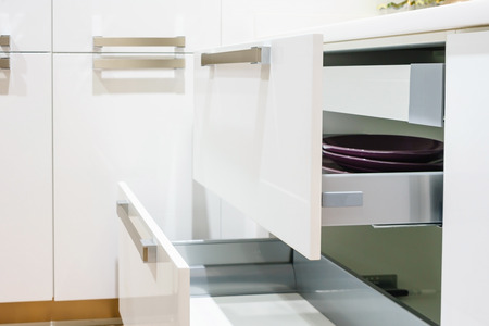 Opened kitchen drawer with plates inside, a smart solution for kitchen storage and organizingの写真素材