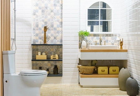 Modern spacious bathroom with bright tiles with toilet and sink. Side viewの写真素材