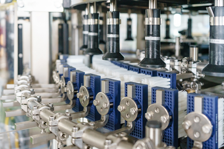 Automated labeling machine equipment with conveyor belt in a beverage factoryの写真素材