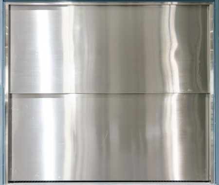 Industrial elevator with closed door at new construction site.の写真素材