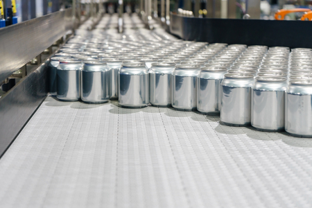 Packed cans on the conveyor belt in berverage factoryの写真素材