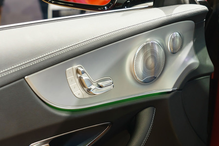 Door handle with Power seat control buttons of a luxury passenger car. interior of the luxury modern...