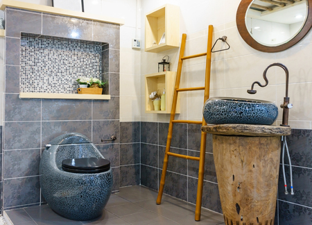 Modern spacious bathroom with bright tiles with toilet and sink. Side viewの写真素材