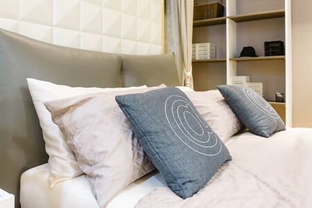 Bed maid-up with clean white pillows and bed sheets in beauty room, Close-up.