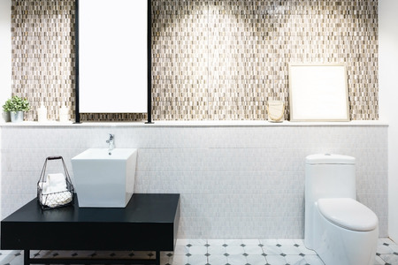 Modern spacious bathroom with bright tiles with toilet and sink. Side viewの写真素材