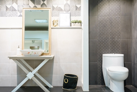 Modern spacious bathroom with bright tiles with toilet and sink. Side viewの写真素材