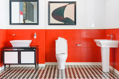 Modern spacious bathroom with bright tiles with toilet and sink. Side viewの写真素材