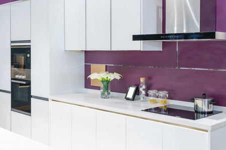 Modern, bright, clean kitchen interior with stainless steel appliances in a luxury apartment.の写真素材