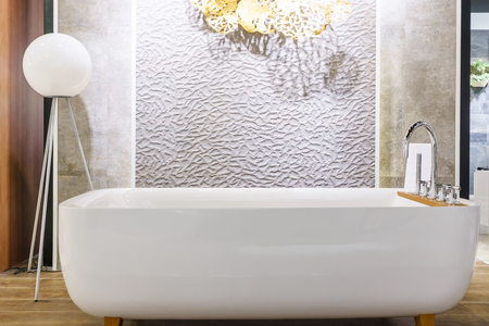 Bathroom interior in cozy colors with modern bathtub