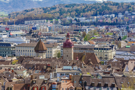 Aerial view of the red tiled roofs of the old town of Lucerne city, wooden Chapel bridge, Reuss...